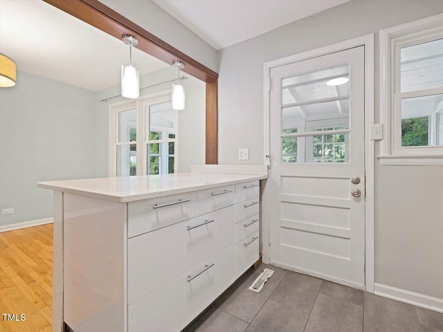 entryway with baseboards and tile patterned floors