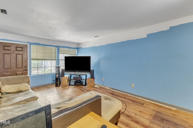 living room featuring baseboards and wood finished floors