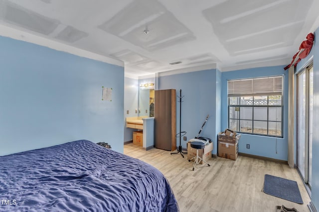 bedroom featuring light wood-type flooring and baseboards