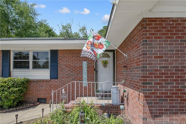 1810 Ashton Rd, Fayetteville, NC 28304 - view of exterior entry featuring brick siding and crawl space