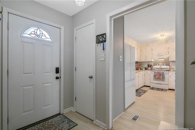 1810 Ashton Rd, Fayetteville, NC 28304 - entrance foyer featuring visible vents, light wood finished floors, and an inviting chandelier