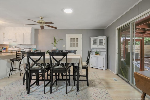 1810 Ashton Rd, Fayetteville, NC 28304 - dining space featuring light wood-type flooring, ornamental molding, ceiling fan, and visible vents