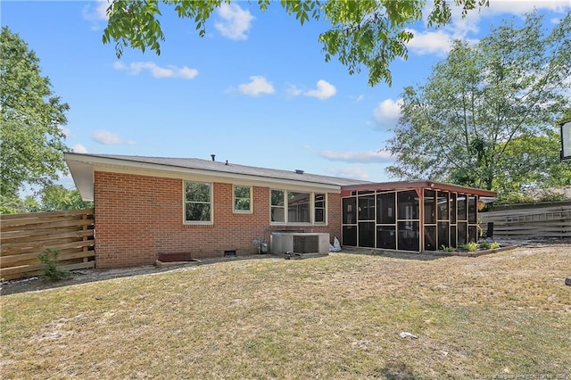 1810 Ashton Rd, Fayetteville, NC 28304 - rear view of property featuring a lawn, brick siding, fence, and a sunroom