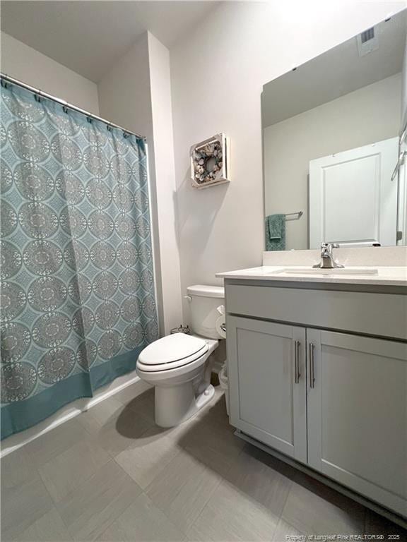 full bath featuring vanity, toilet, and visible vents