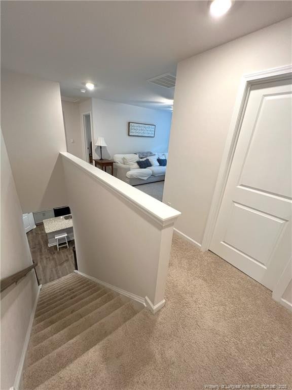stairway with carpet floors, recessed lighting, baseboards, and visible vents