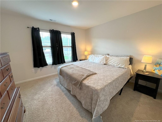 carpeted bedroom with baseboards and visible vents