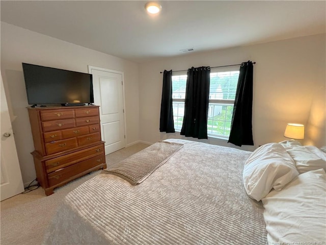 bedroom featuring light carpet and visible vents