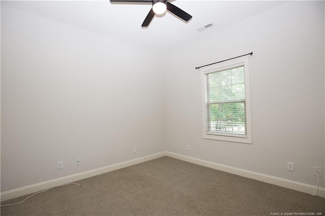 carpeted empty room with baseboards, ceiling fan, and visible vents