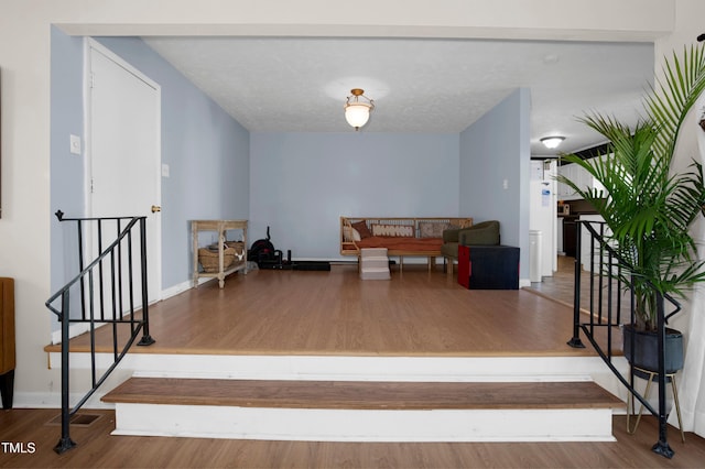 staircase featuring baseboards and wood finished floors