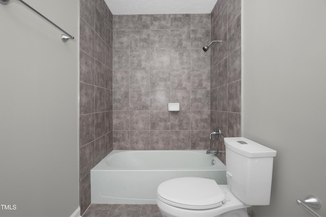 bathroom featuring tile patterned floors, toilet, and shower / washtub combination