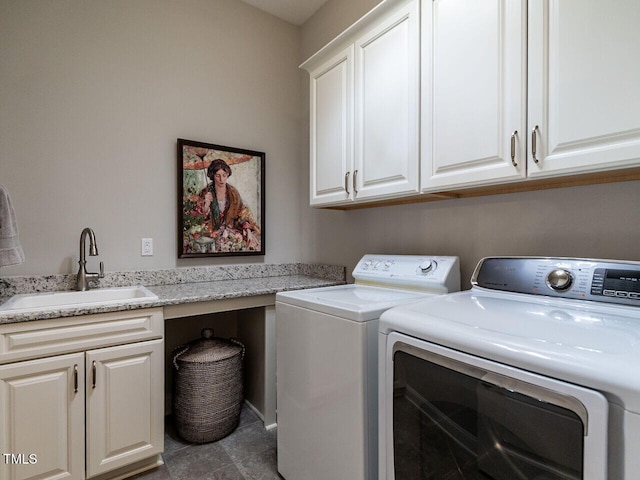 clothes washing area featuring cabinet space and independent washer and dryer