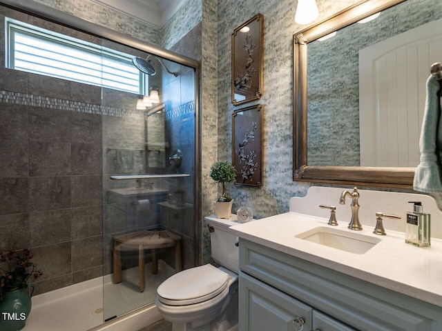 full bath with toilet, a shower stall, vanity, and wallpapered walls