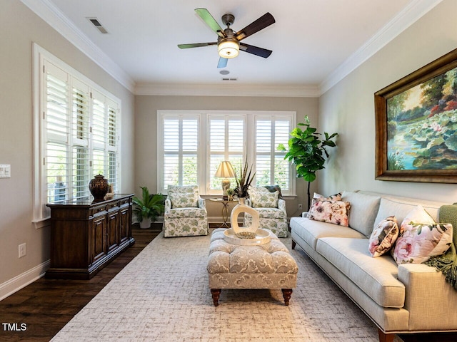 living area with dark wood-style flooring, ceiling fan, crown molding, and baseboards