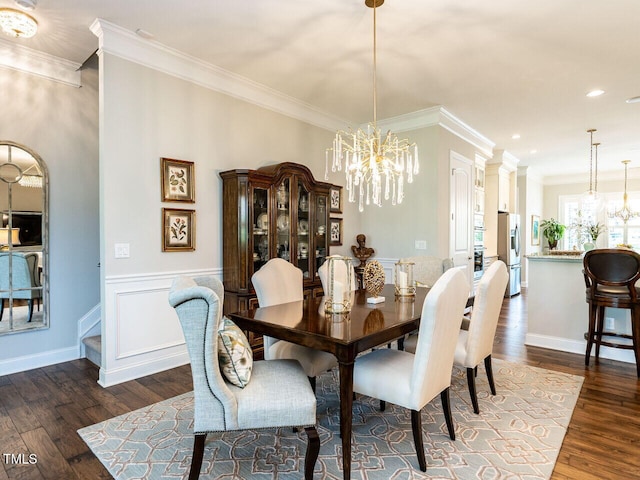 dining area with a chandelier, dark wood finished floors, crown molding, recessed lighting, and a wainscoted wall