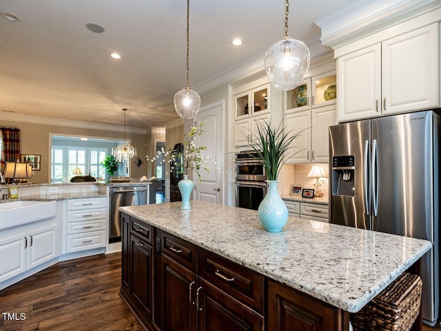 kitchen with stainless steel appliances, ornamental molding, glass insert cabinets, recessed lighting, and decorative backsplash
