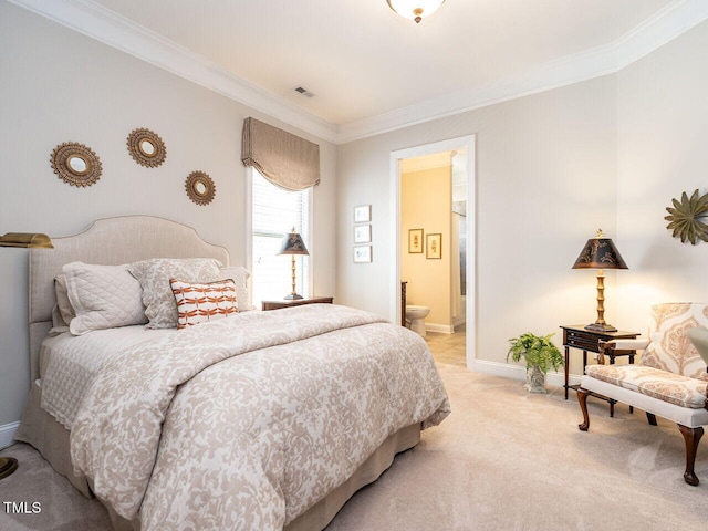 bedroom with crown molding, light carpet, baseboards, and ensuite bathroom