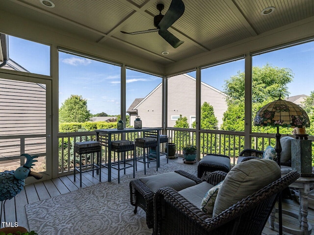 sunroom / solarium featuring a ceiling fan and healthy amount of natural light