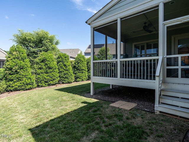 view of green lawn with a sunroom