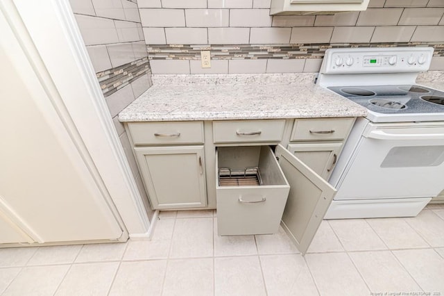 interior details with light stone counters, white electric range oven, and tasteful backsplash