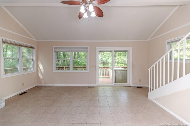 spare room featuring ceiling fan, vaulted ceiling, light tile patterned floors, and visible vents