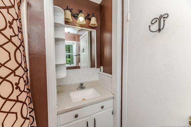 bathroom with vanity and decorative backsplash