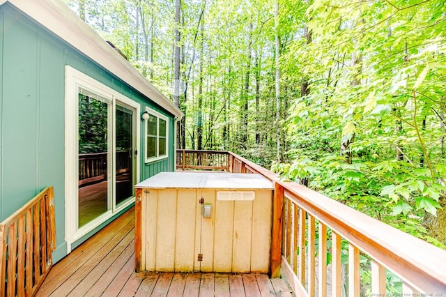 wooden terrace featuring a view of trees