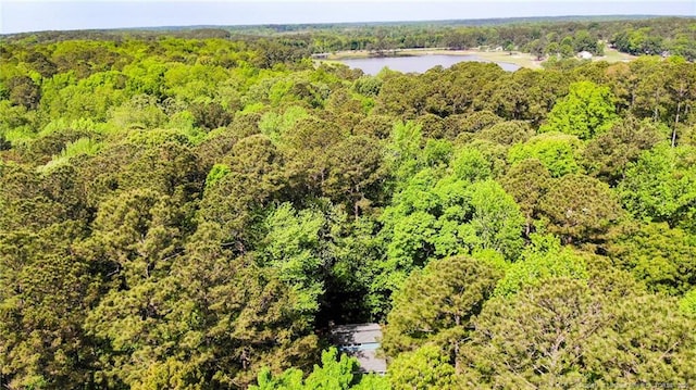 aerial view with a forest view and a water view