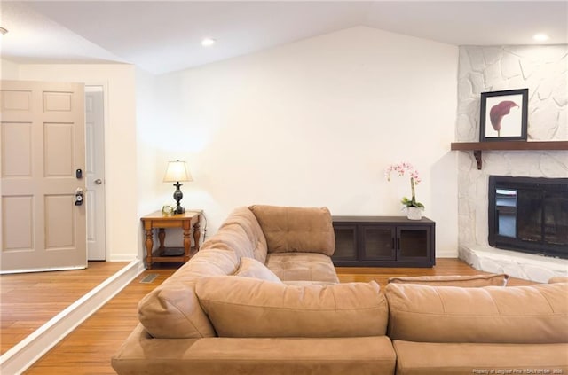 6739 Irongate Dr Unit B, Fayetteville, NC 28306 - living room with a stone fireplace, vaulted ceiling, wood finished floors, baseboards, and recessed lighting