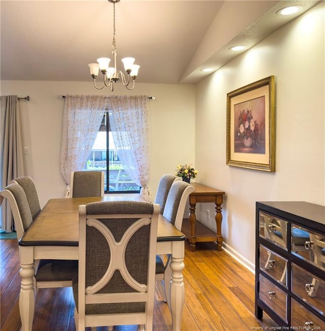 6739 Irongate Dr Unit B, Fayetteville, NC 28306 - dining space with baseboards, a chandelier, lofted ceiling, and hardwood / wood-style flooring