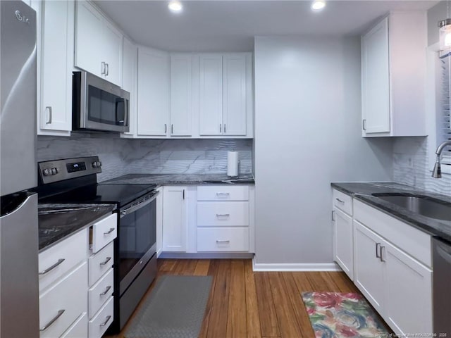 6739 Irongate Dr Unit B, Fayetteville, NC 28306 - kitchen featuring recessed lighting, appliances with stainless steel finishes, a sink, and dark wood-type flooring
