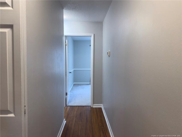 6739 Irongate Dr Unit B, Fayetteville, NC 28306 - hall with a textured ceiling, baseboards, and dark wood-type flooring
