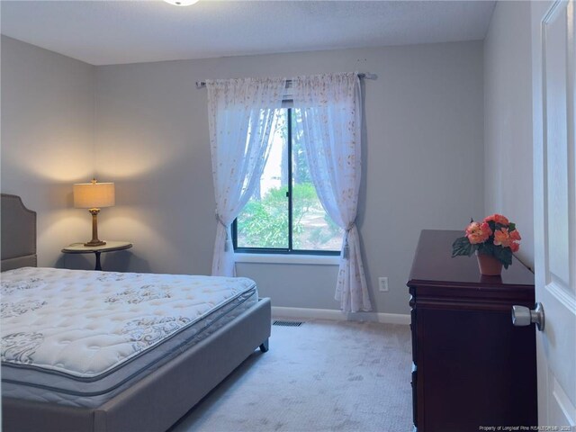6739 Irongate Dr Unit B, Fayetteville, NC 28306 - bedroom featuring light colored carpet, baseboards, and visible vents