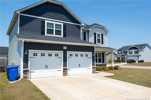 craftsman inspired home with concrete driveway, stone siding, an attached garage, and a front yard