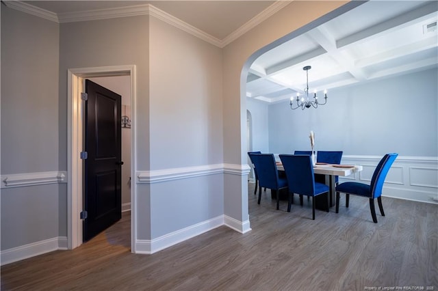dining room featuring beam ceiling, arched walkways, a chandelier, wood finished floors, and coffered ceiling