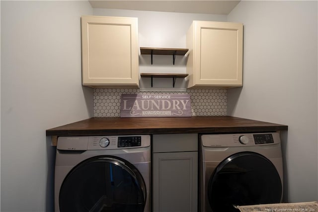 washroom with washer / clothes dryer and cabinet space