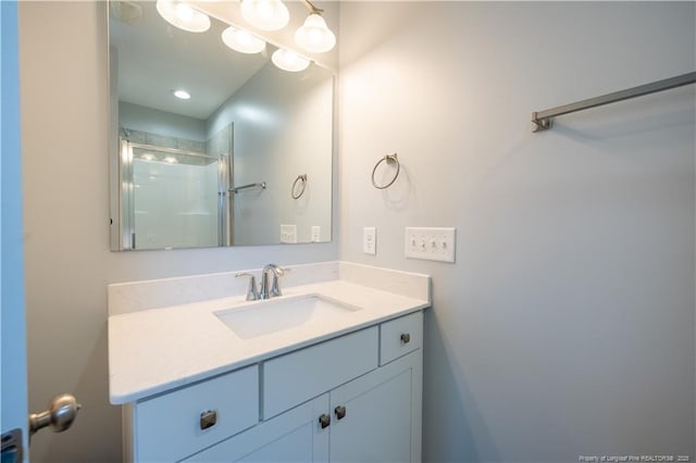 bathroom featuring vanity and a shower with shower door