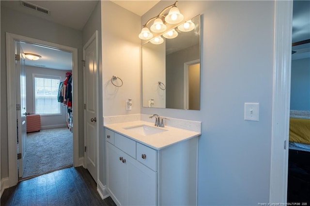 bathroom with visible vents, baseboards, and vanity
