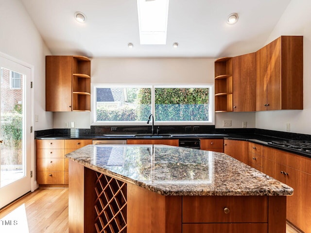 1605 Park Dr, Raleigh, NC 27605 - kitchen featuring a kitchen island, open shelves, a sink, dark stone countertops, and light wood-style flooring