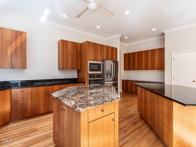 1605 Park Dr, Raleigh, NC 27605 - kitchen featuring a kitchen island, appliances with stainless steel finishes, brown cabinetry, and light wood-style floors