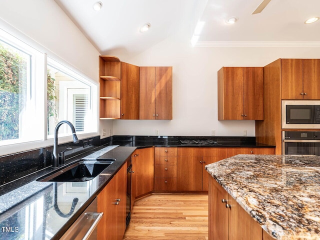 1605 Park Dr, Raleigh, NC 27605 - kitchen featuring a sink, stainless steel oven, brown cabinets, and a healthy amount of sunlight