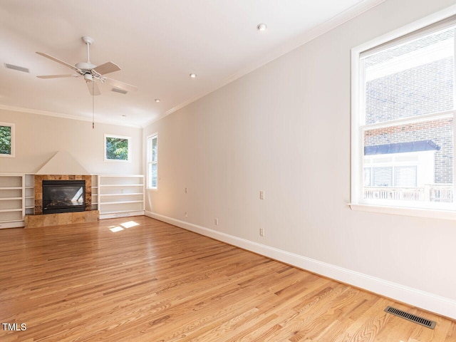 1605 Park Dr, Raleigh, NC 27605 - unfurnished living room featuring crown molding, visible vents, and light wood-type flooring