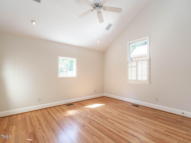 1605 Park Dr, Raleigh, NC 27605 - unfurnished room featuring baseboards, vaulted ceiling, a wealth of natural light, and light wood-type flooring