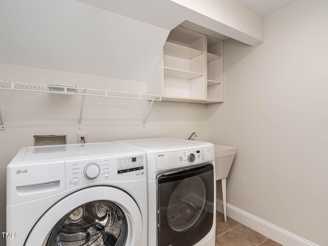 1605 Park Dr, Raleigh, NC 27605 - clothes washing area featuring baseboards, light tile patterned flooring, laundry area, and washer and clothes dryer