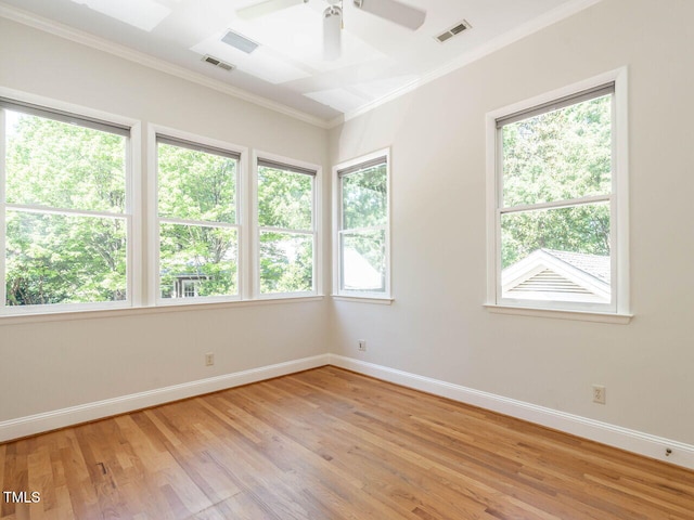 1605 Park Dr, Raleigh, NC 27605 - unfurnished room with visible vents, baseboards, light wood finished floors, ornamental molding, and a wealth of natural light