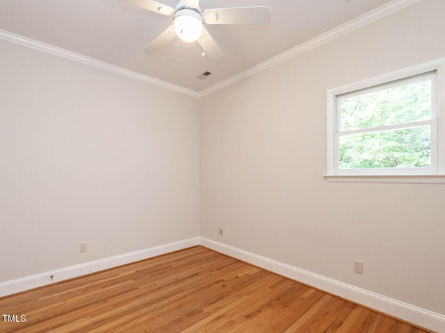 1605 Park Dr, Raleigh, NC 27605 - spare room featuring a ceiling fan, visible vents, light wood-type flooring, baseboards, and ornamental molding
