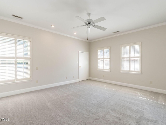 1605 Park Dr, Raleigh, NC 27605 - unfurnished room featuring crown molding, baseboards, plenty of natural light, and visible vents
