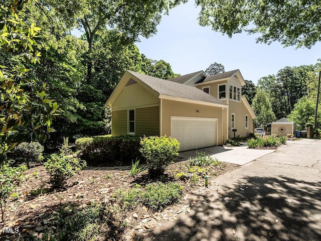 1605 Park Dr, Raleigh, NC 27605 - view of home's exterior featuring roof with shingles, an attached garage, and driveway
