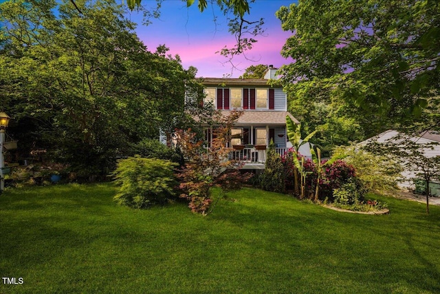 view of front of property with a yard and a chimney