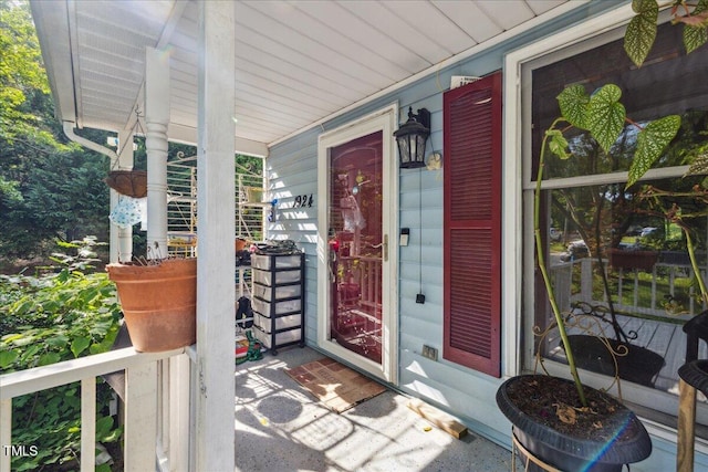 view of exterior entry featuring a porch