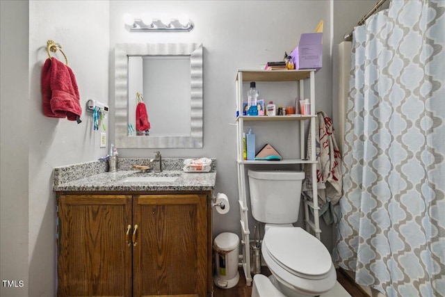 bathroom with vanity, toilet, and curtained shower